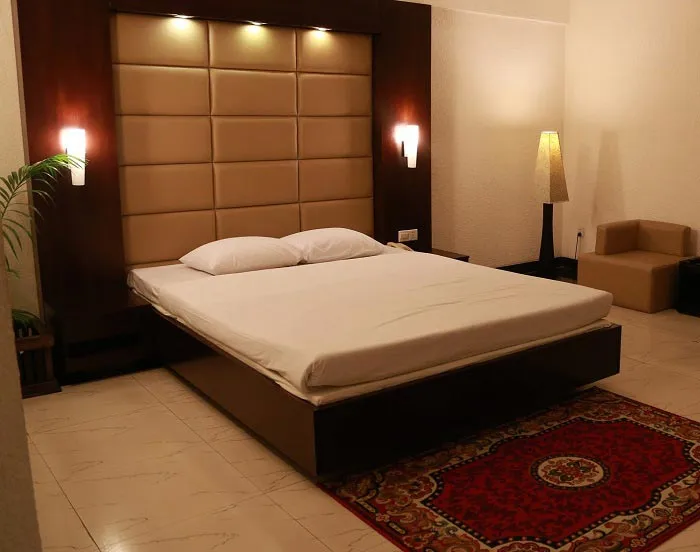 Guest room with a double bed and patterned rug