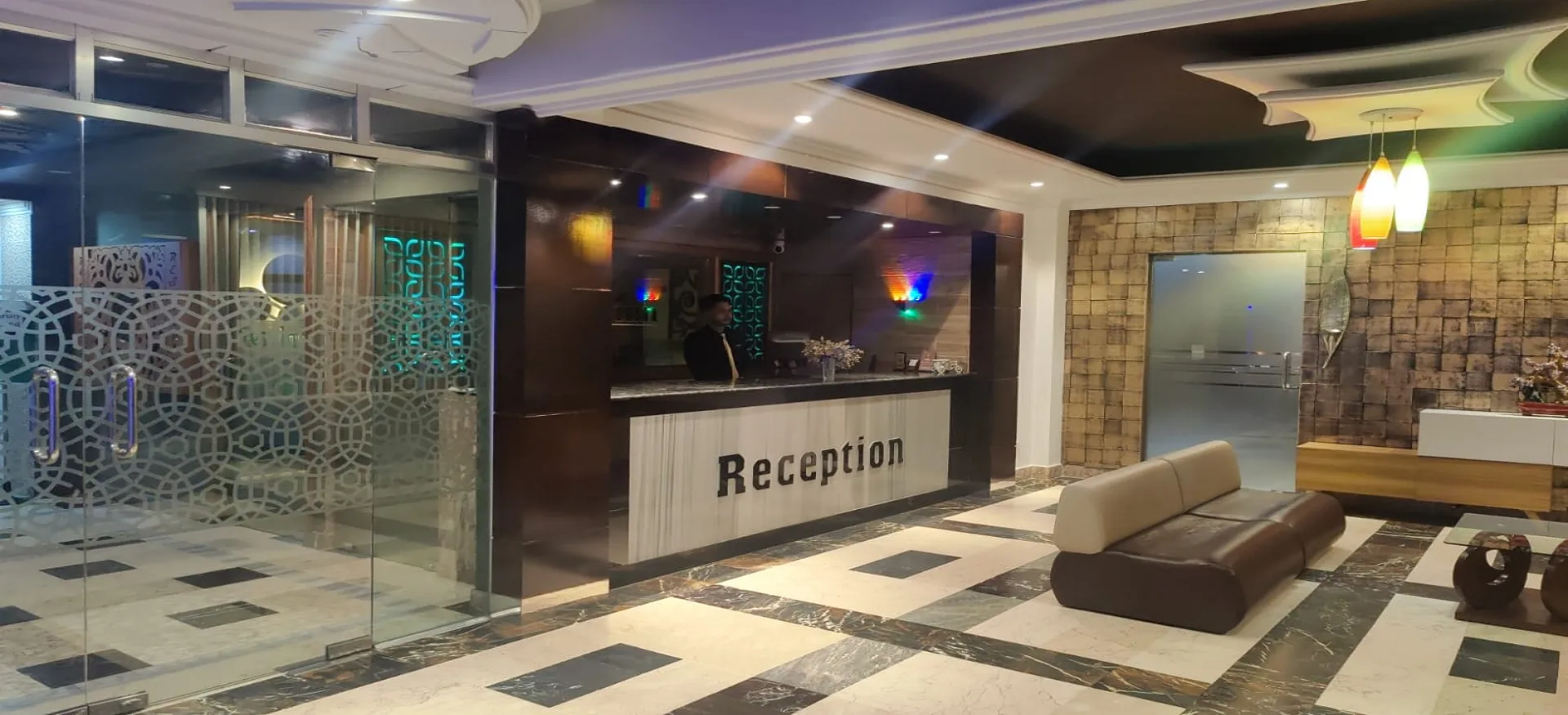 Hotel lobby with a reception desk and lounge seating
