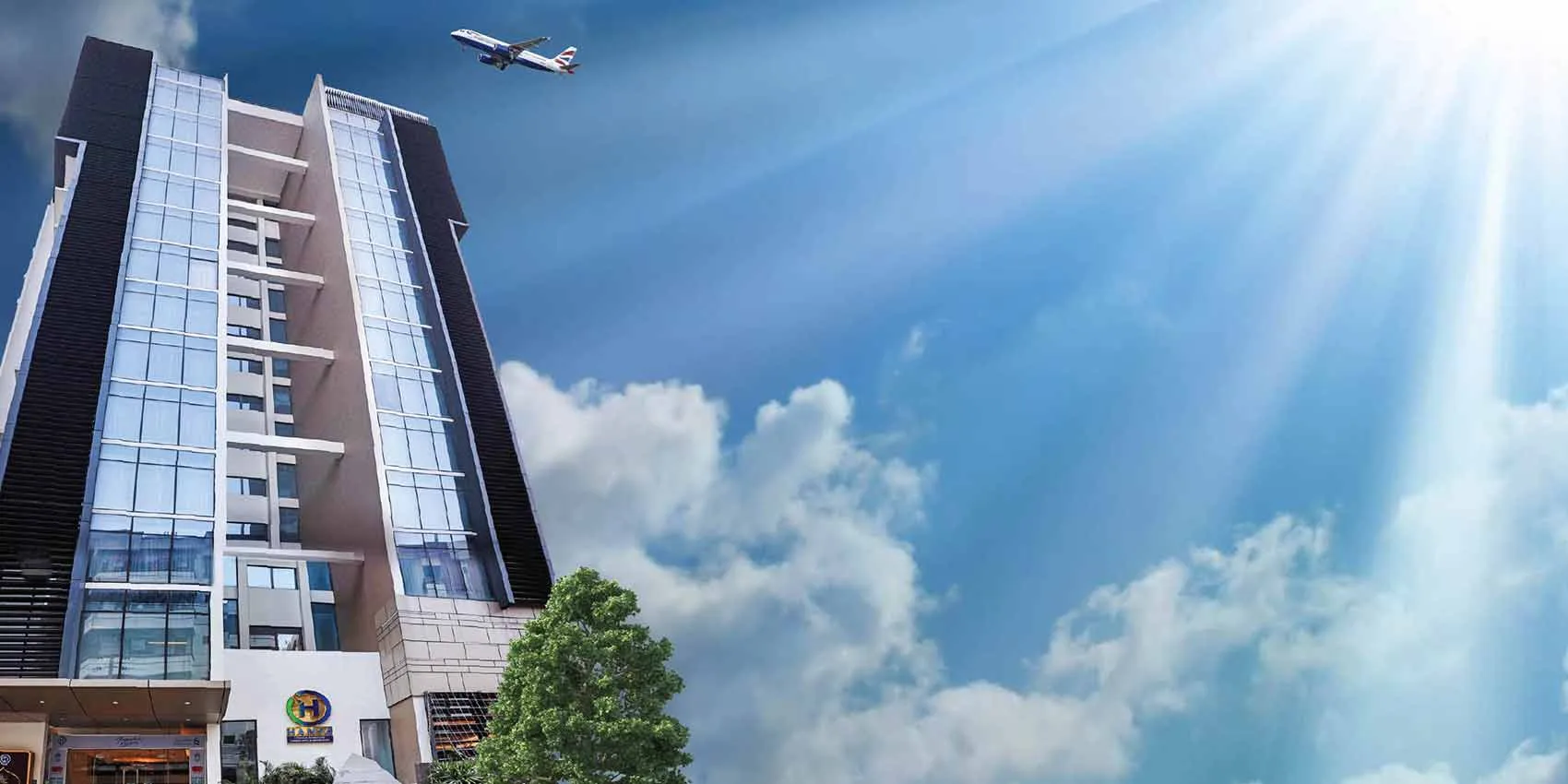 HANSA tower seen from the street with the HANSA logo at its entrance (promotional image with an aircraft overhead)
