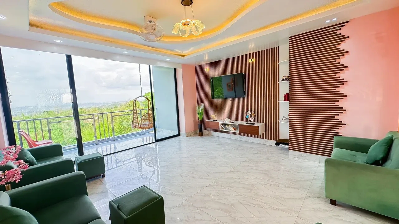 Lounge with green sofas and a hanging chair on the terrace