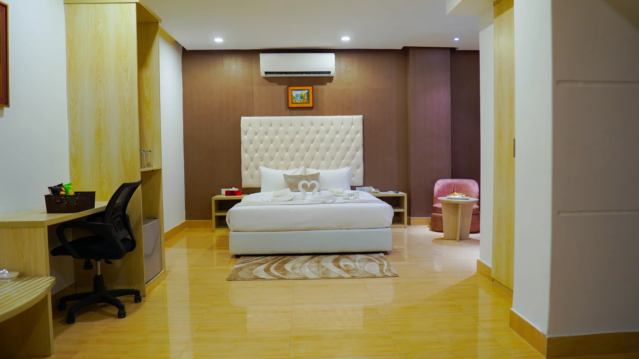 Guest room with a double bed and a white padded headboard at Grand Vistana