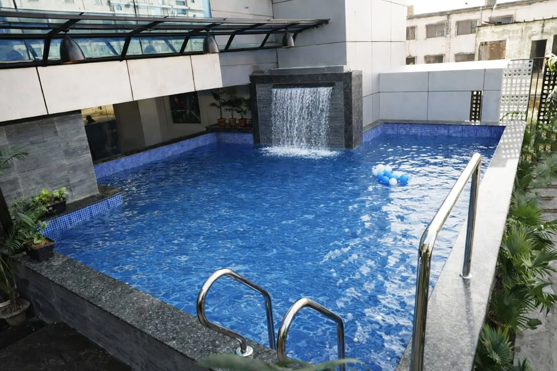Indoor swimming pool with a water-wall at Best Western SKS Chattogram