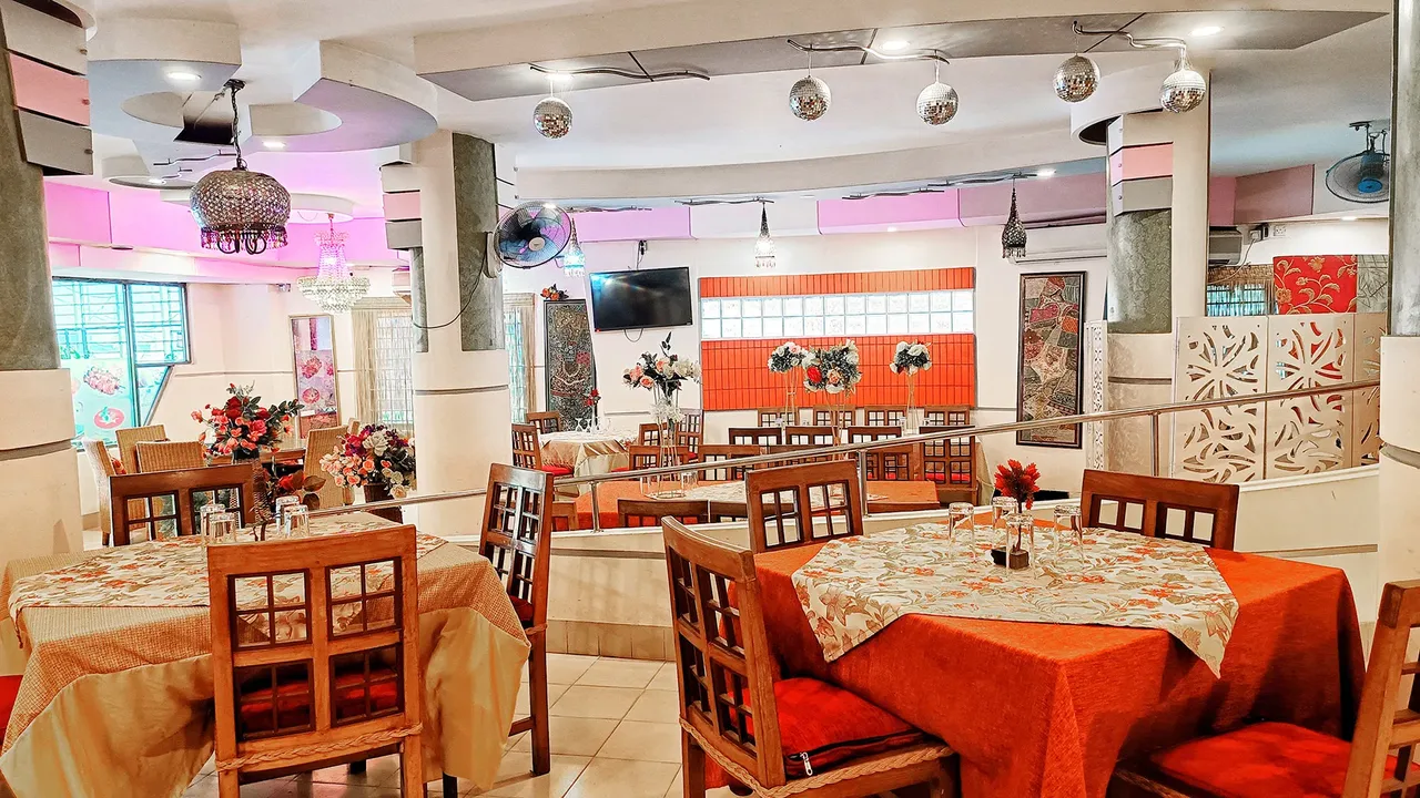 Restaurant hall with set tables and cushioned chairs