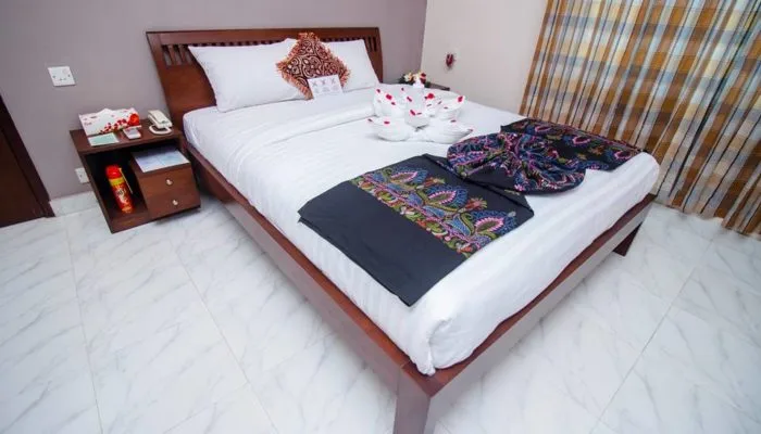 Bedroom with a double bed and checked curtains