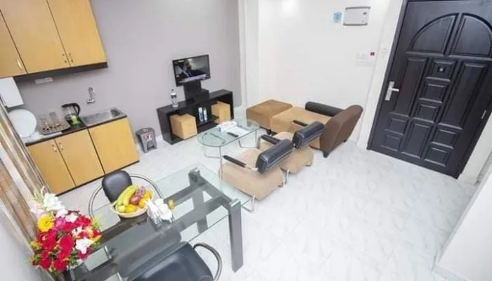 Suite living area with a kitchenette, sofas and dining table