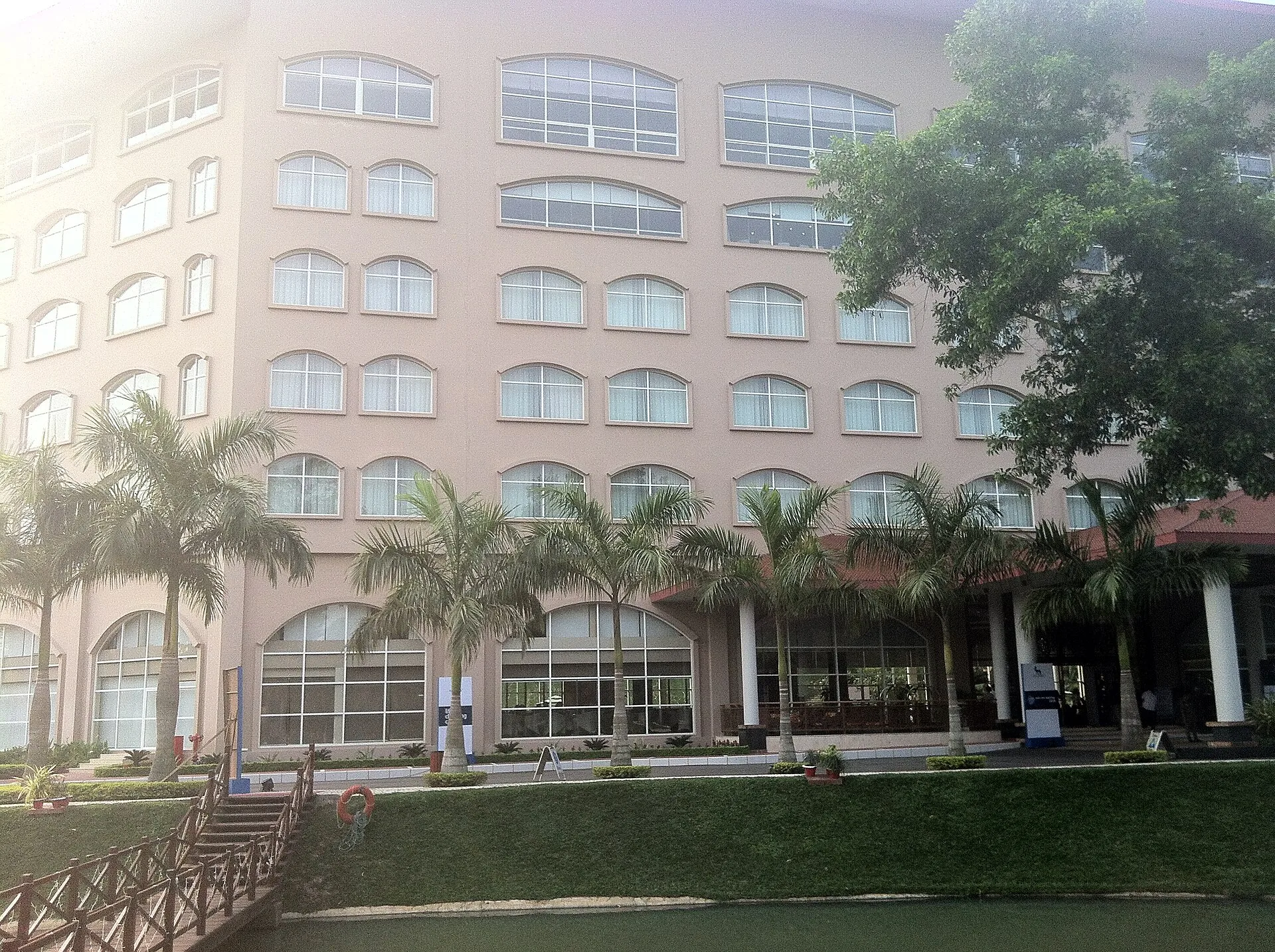 Resort building behind palms and a lawn