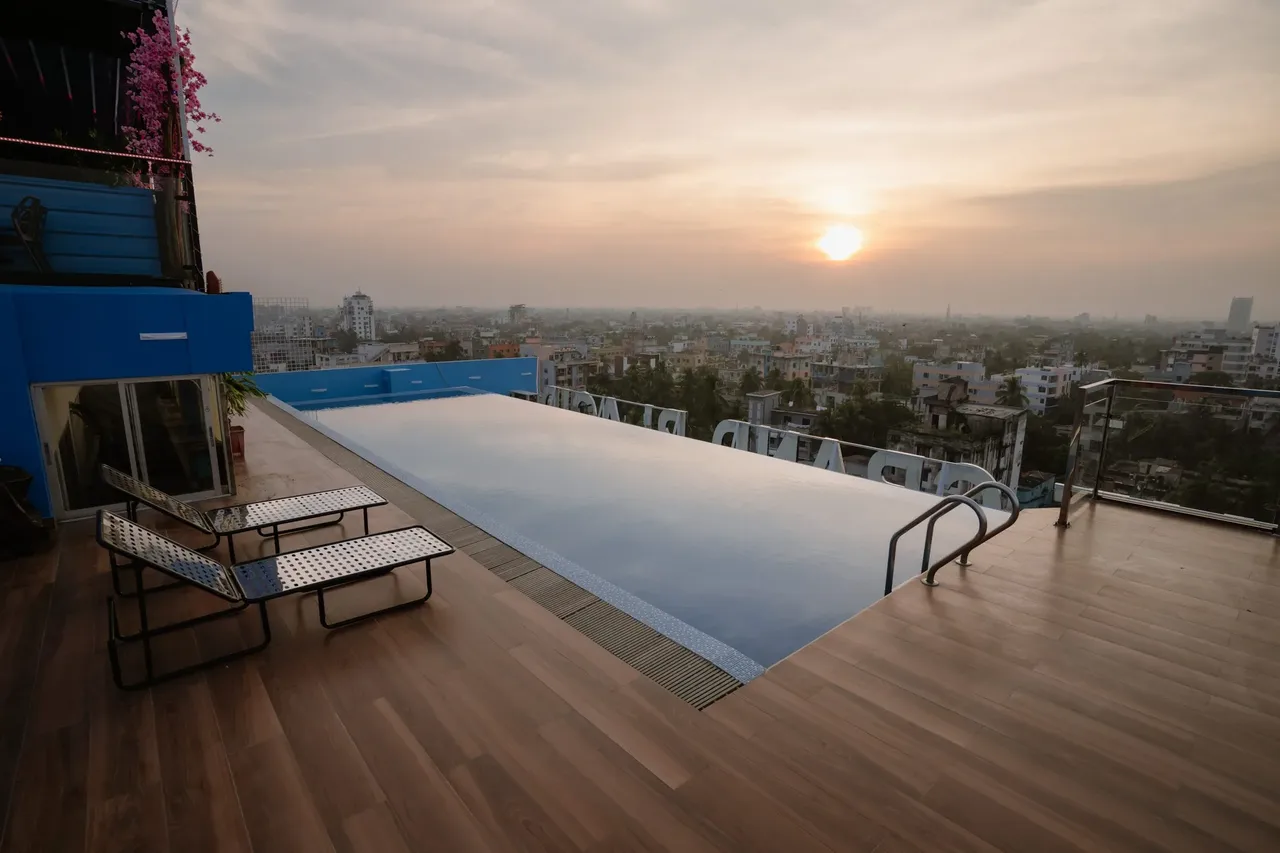 Rooftop swimming pool at sunset with a view over Khulna