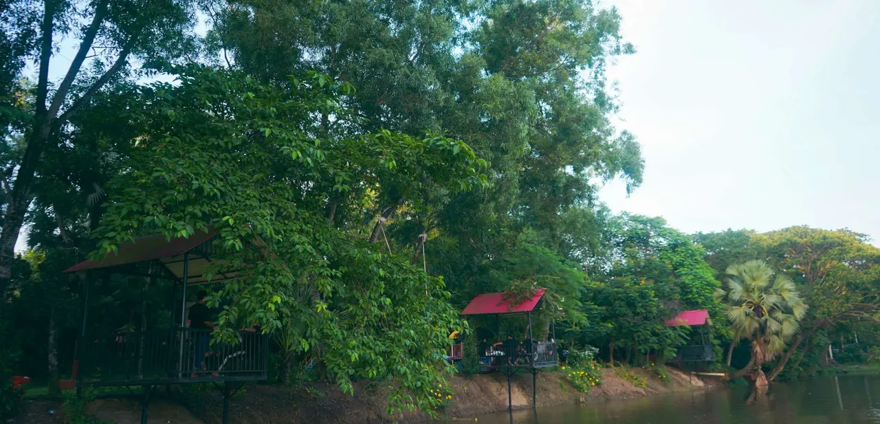 Lakeside cottage seen through trees at Chuti Resort Gazipur