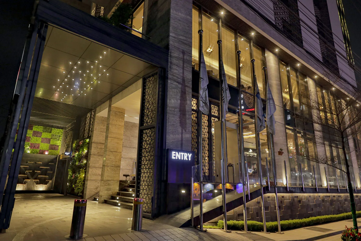 Entrance of Best Western PLUS Runway lit up at night