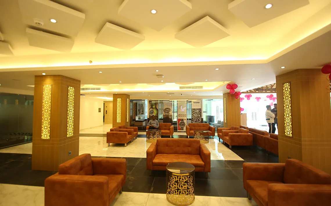 Lobby lounge with orange sofas and carved wooden screens