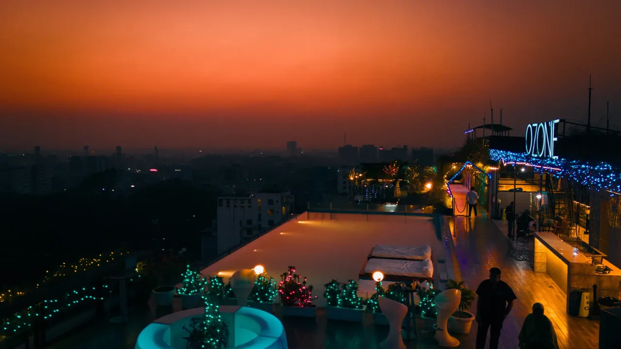 Rooftop infinity pool and lounge area at dusk