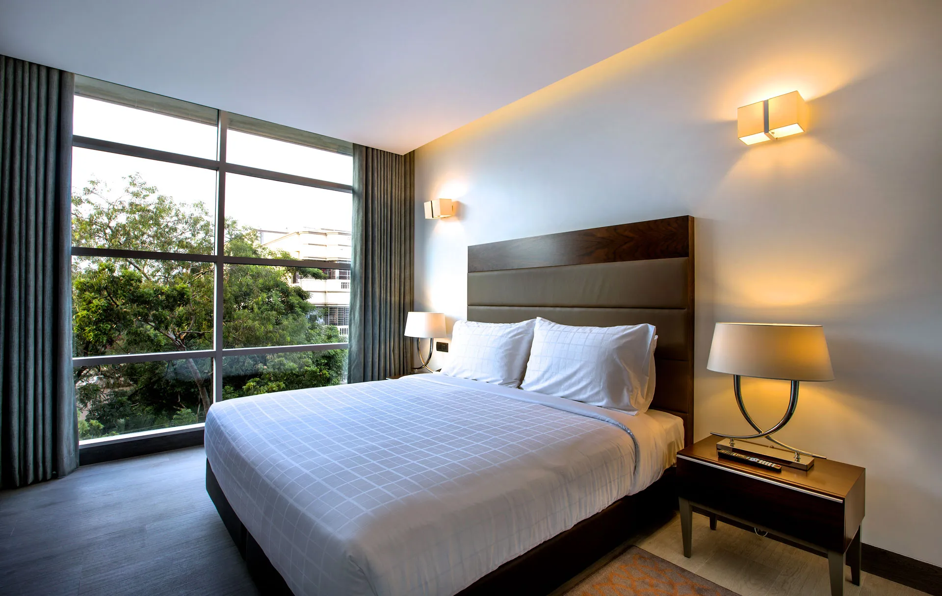 Guest bedroom with garden-view window at Space Hotel and Apartments