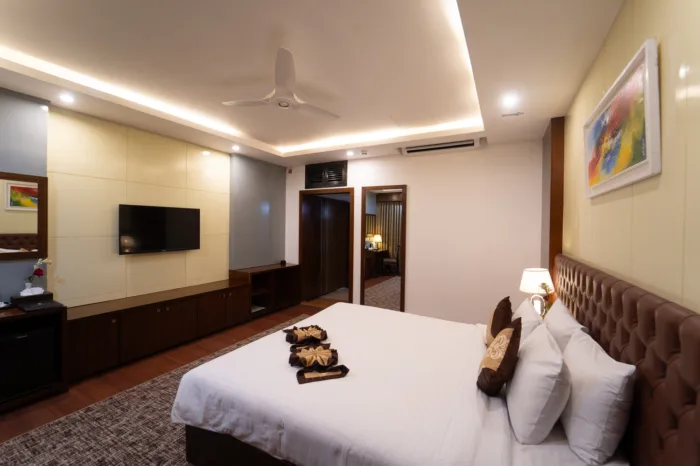Deluxe room with a king bed and wall-mounted TV