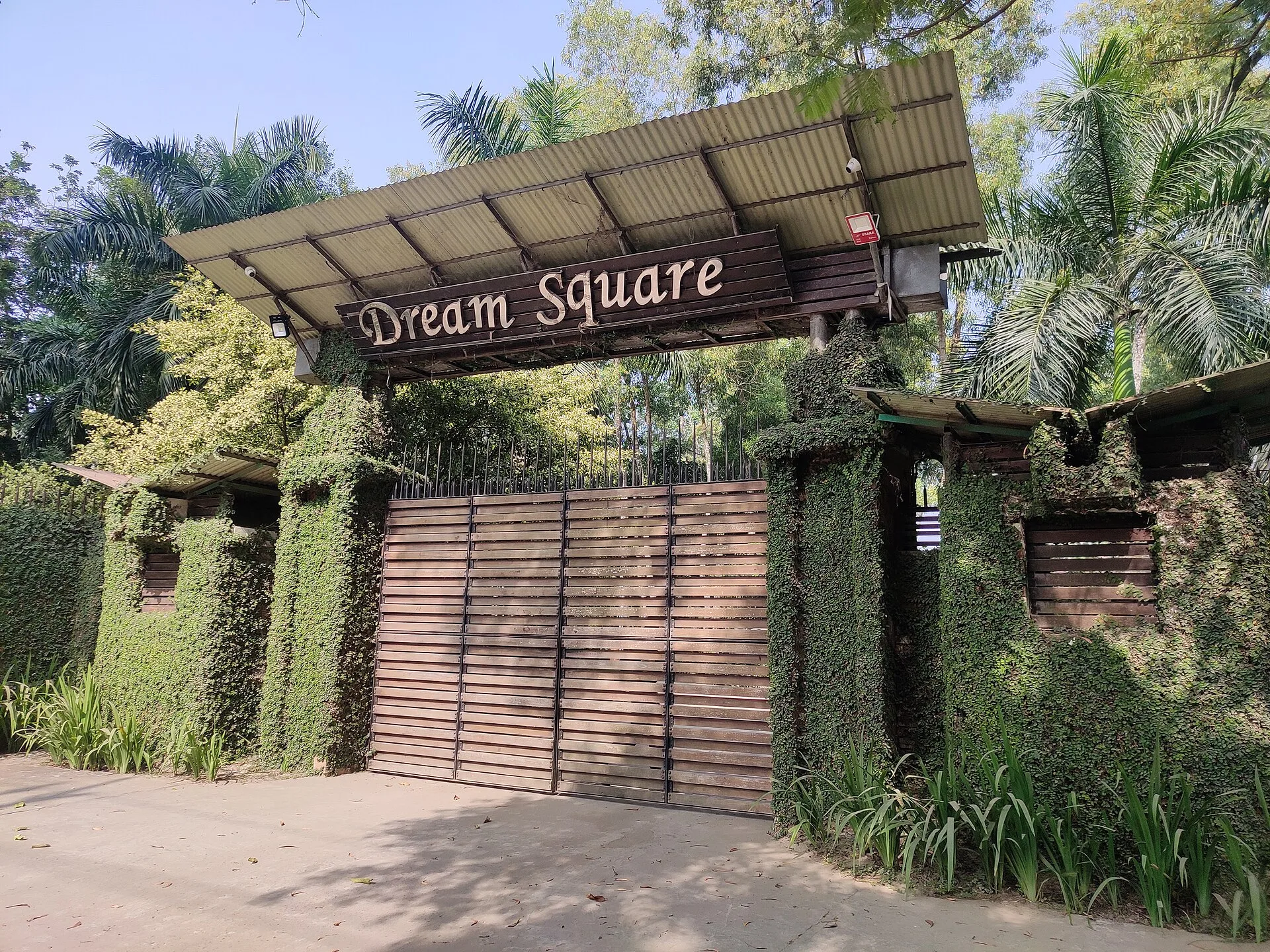 Timber entrance gate with the Dream Square sign