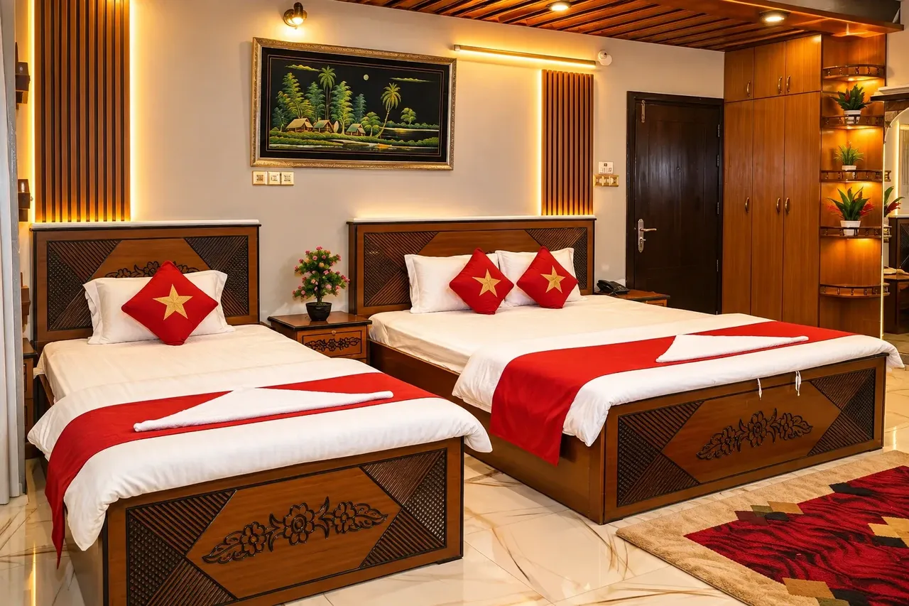 Twin room with carved wooden beds and red bedspreads