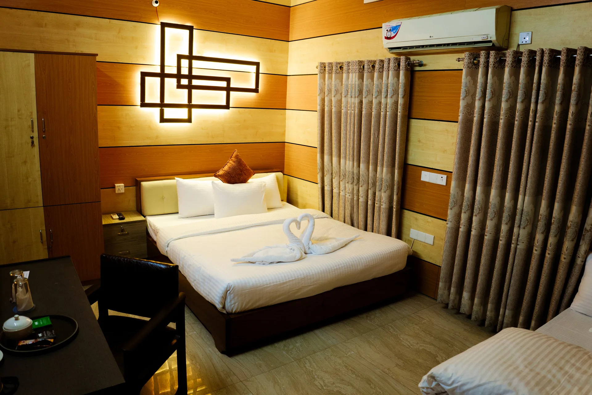 Deluxe king room with a carved wall panel and curtains