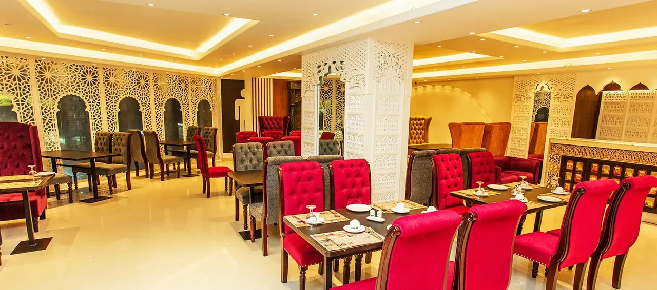 Restaurant dining room with red upholstered chairs
