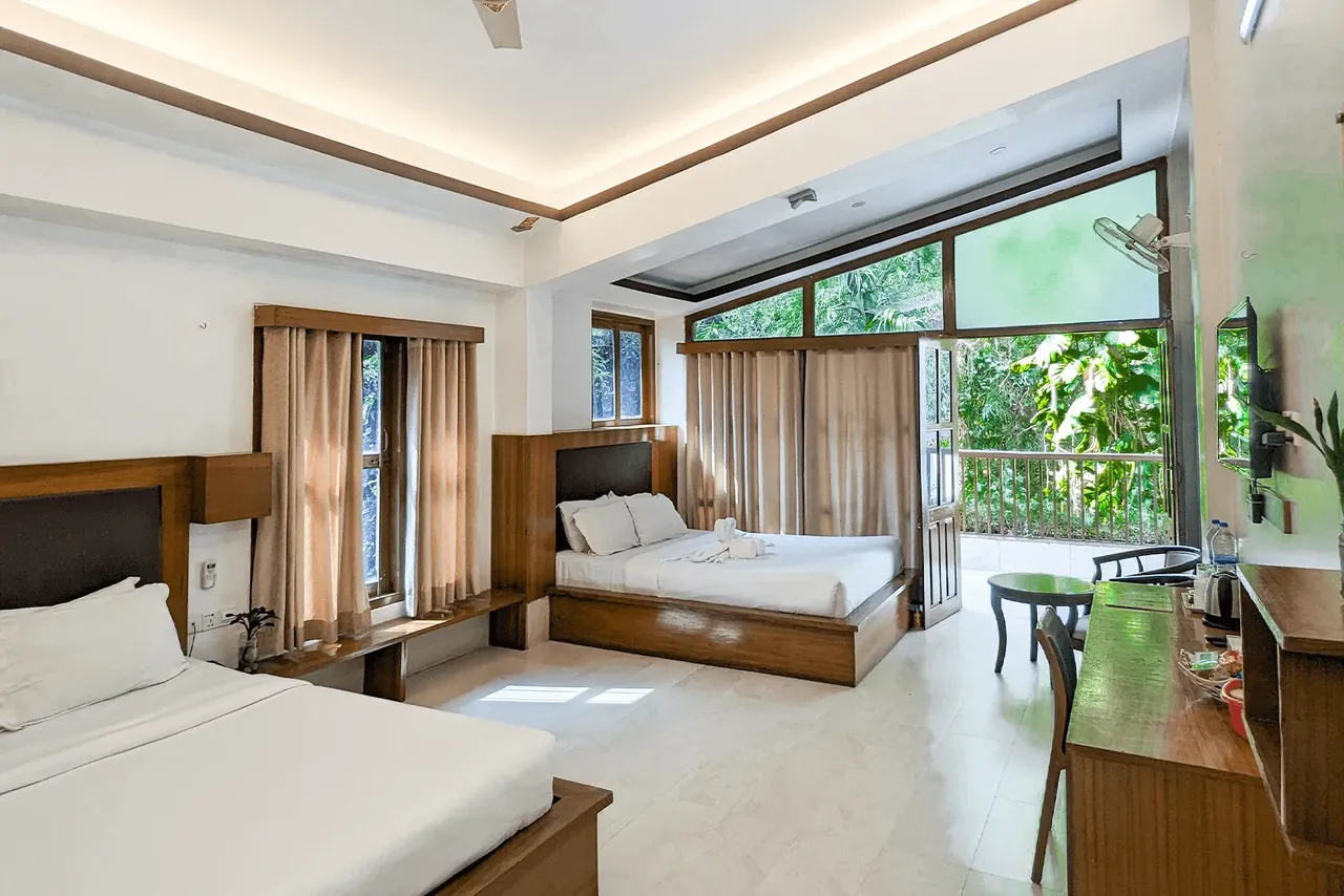 Villa bedroom with large windows onto the forest