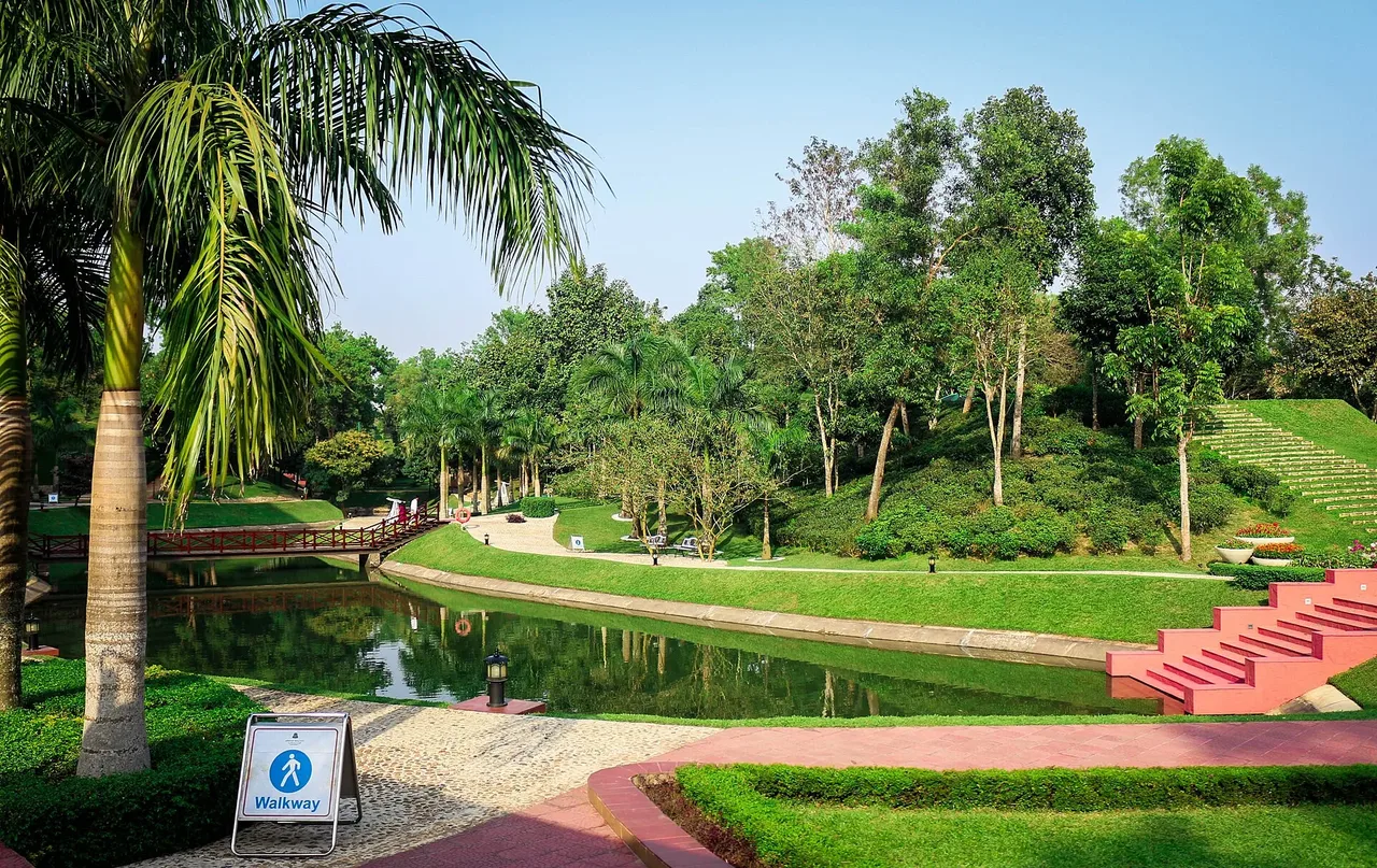 Lakeside lawn with palms and a stepped path in the resort grounds
