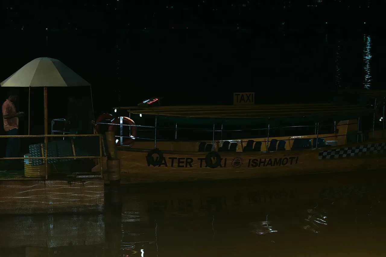 A night view of a Hatirjheel Water Taxi named "Ishamoti" (ইছামতী) moored at a passenger terminal dock in Hatirjheel, Dhaka, Bangladesh.