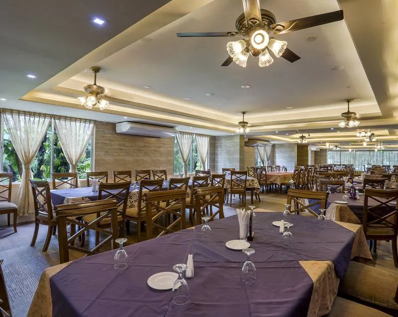 Restaurant hall with ceiling fans and set tables