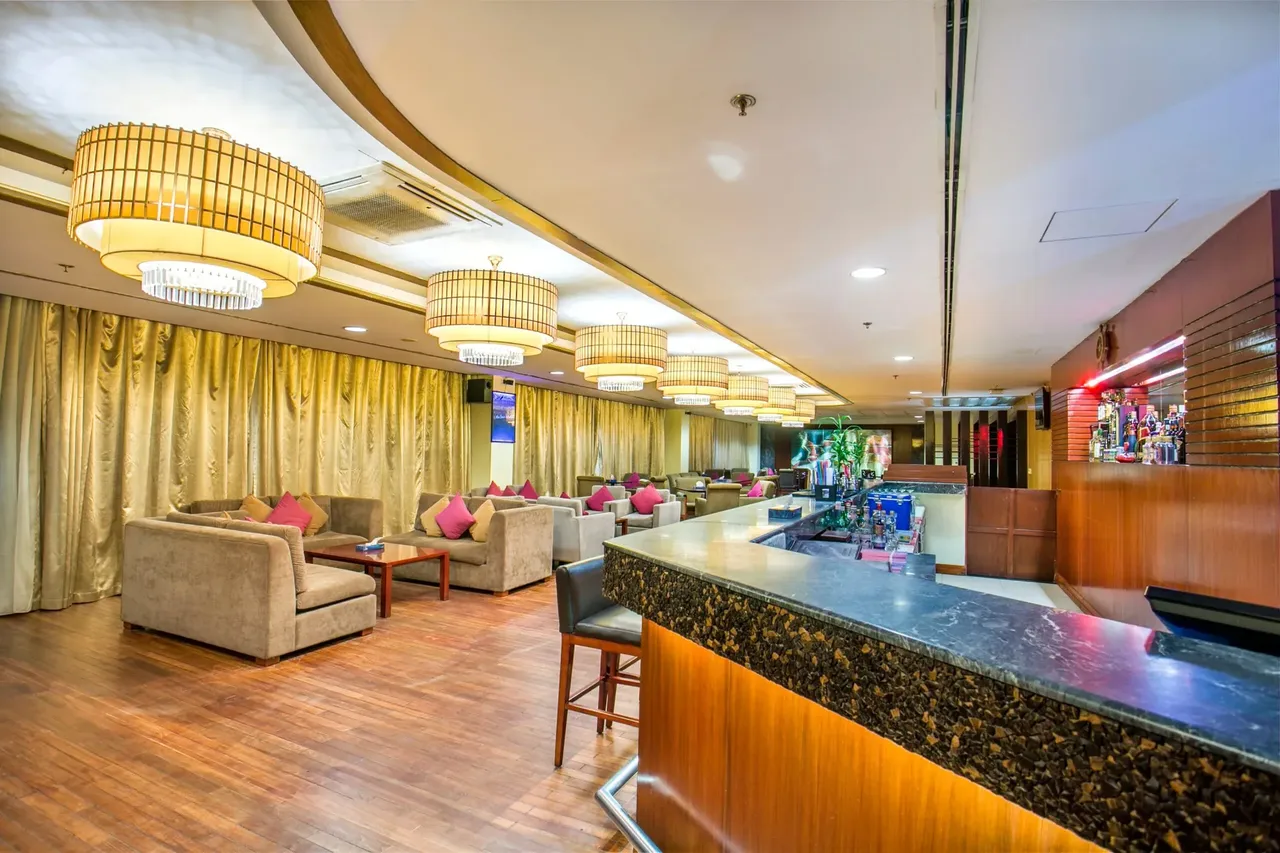 Lounge and bar with sofas and a lit counter