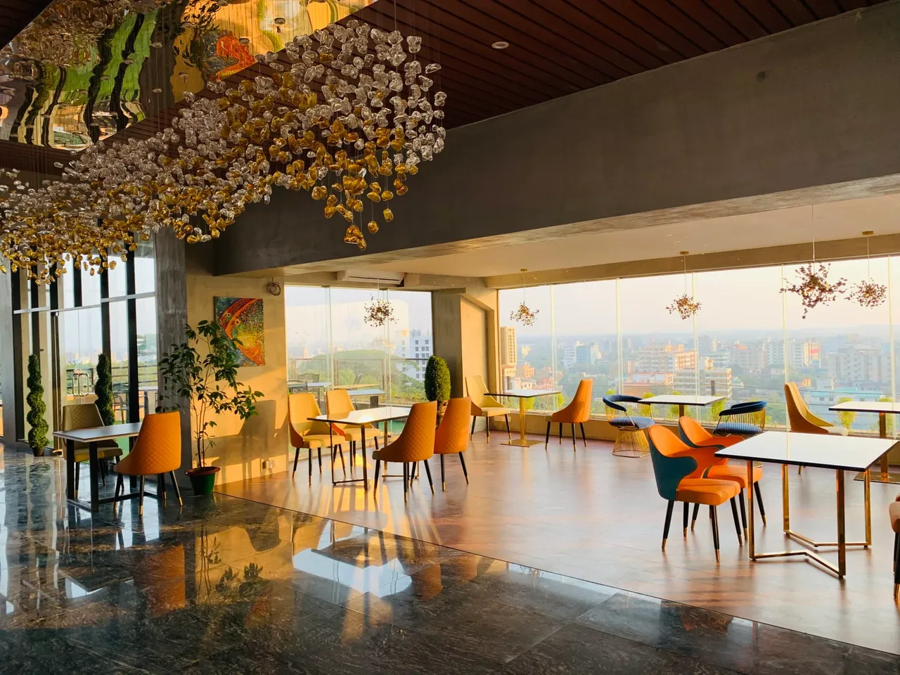 Rooftop restaurant with floor-to-ceiling windows over the city