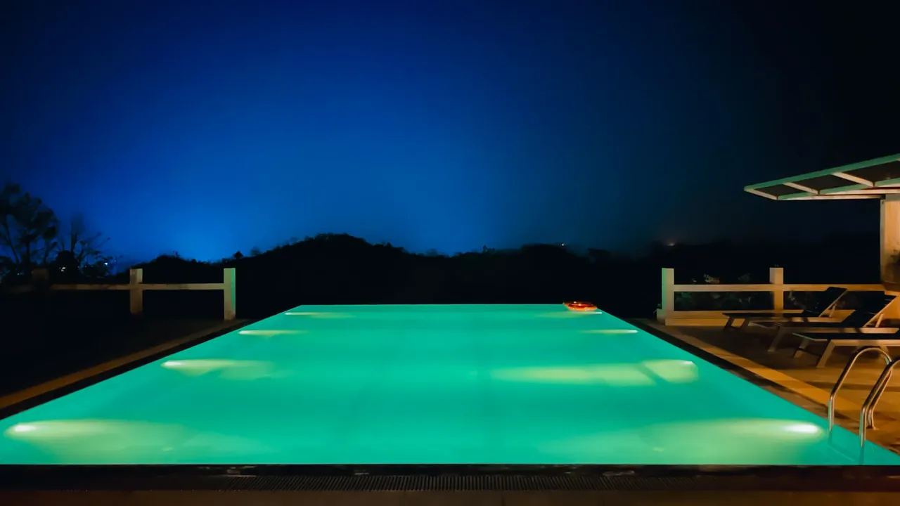Infinity pool lit at night at Labah Tong Hill Resort