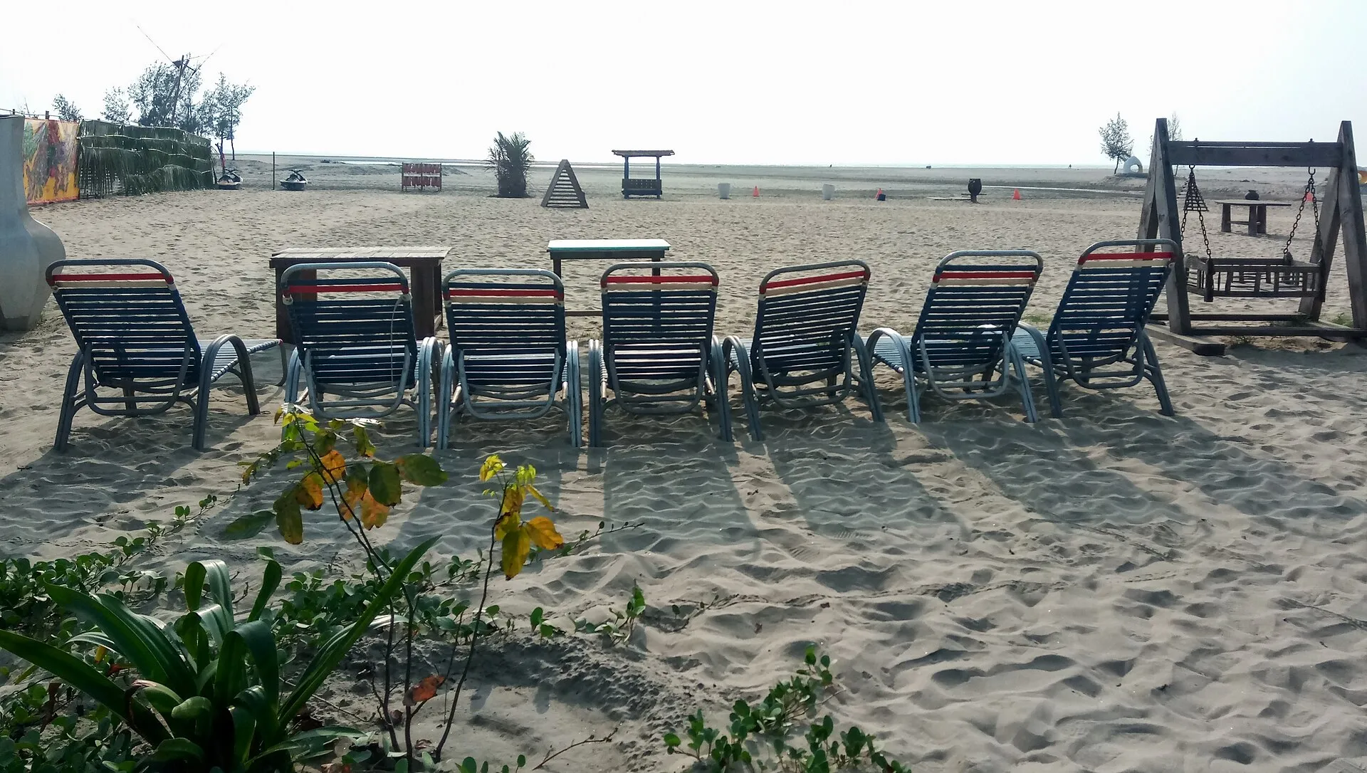 Sun loungers and a swing on the sand at Mermaid Beach Resort