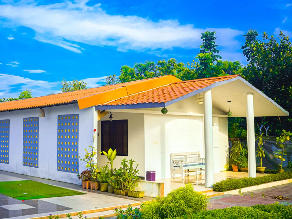 Garden cottages under a blue sky at RASS Resort