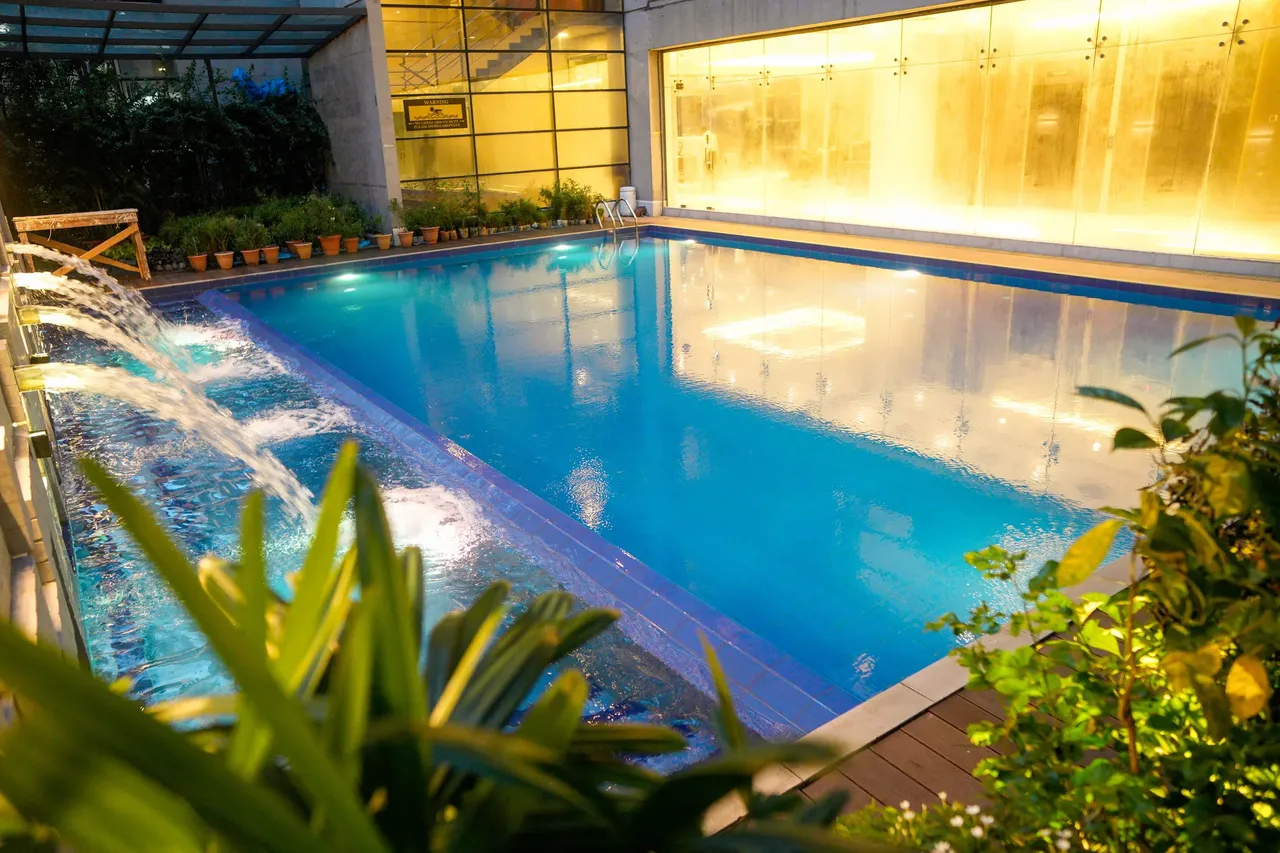 Outdoor swimming pool with a waterfall feature at Lakeshore Heights