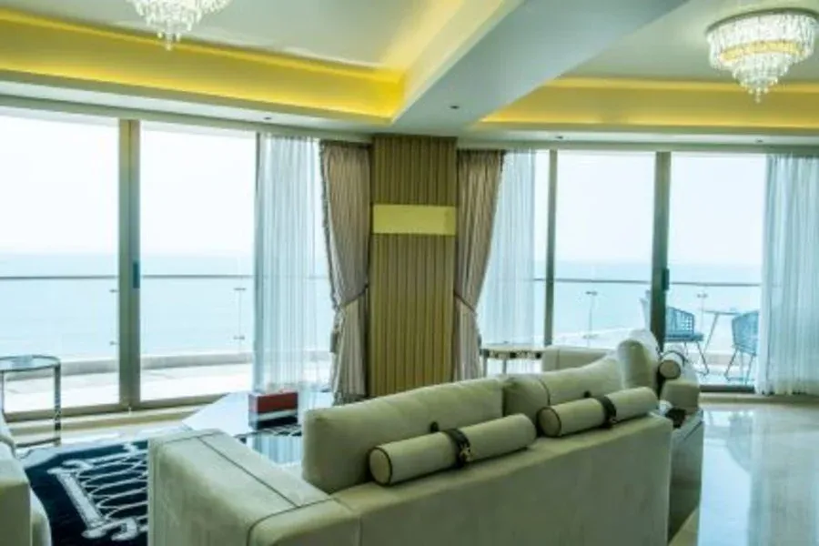 Suite living room with sea-view windows at Ramada Cox's Bazar