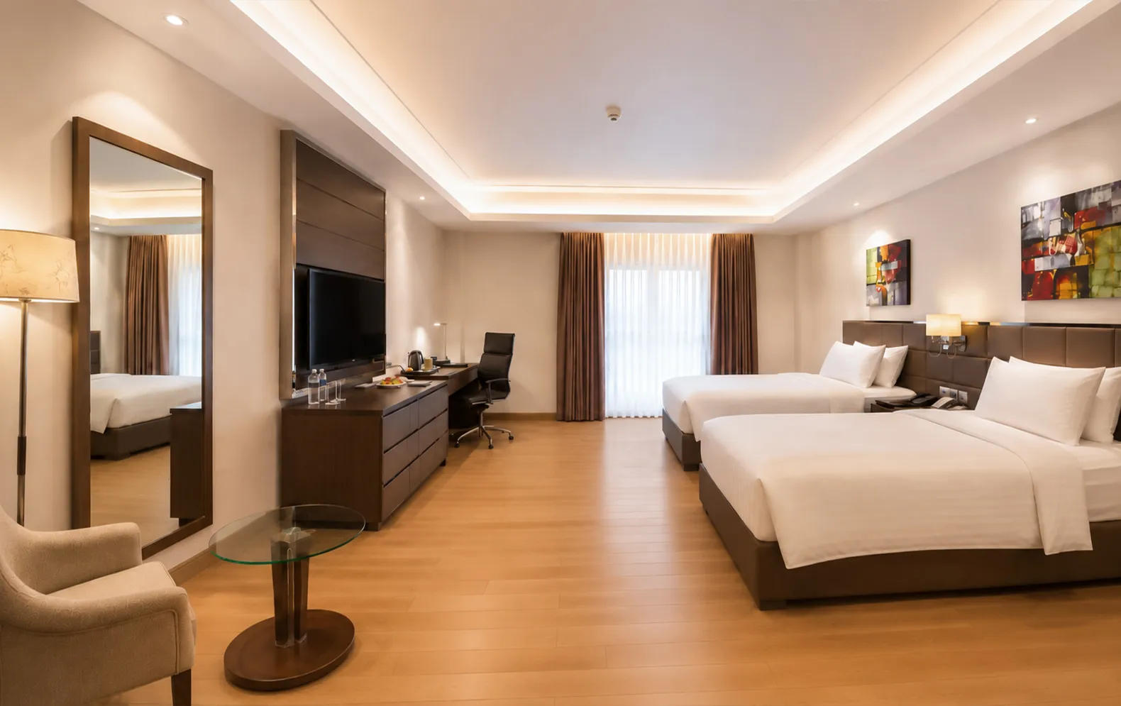 Deluxe Twin room with two single beds and a work desk at Golden Tulip The Grandmark Dhaka