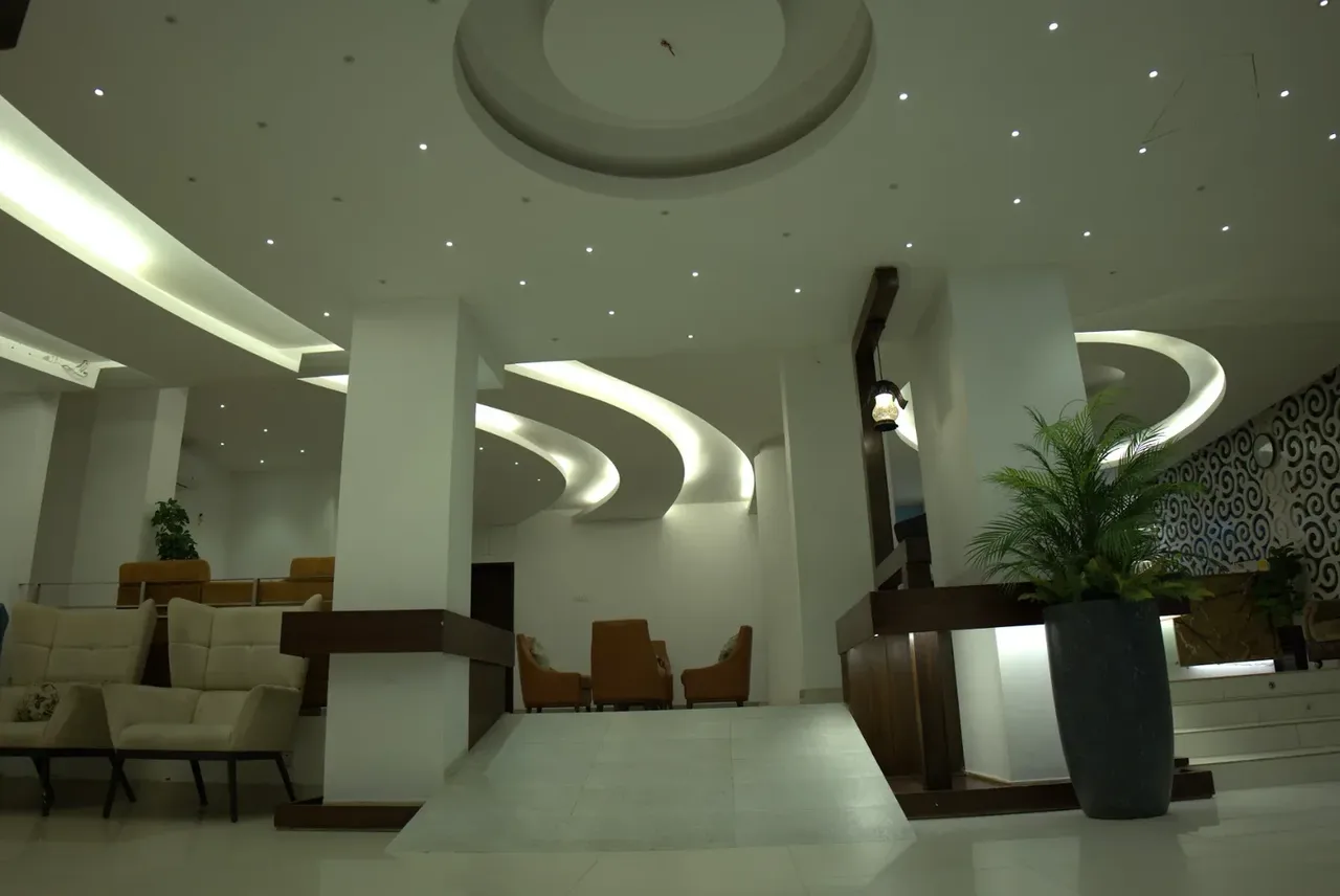 Lobby with seating and a curved ceiling light