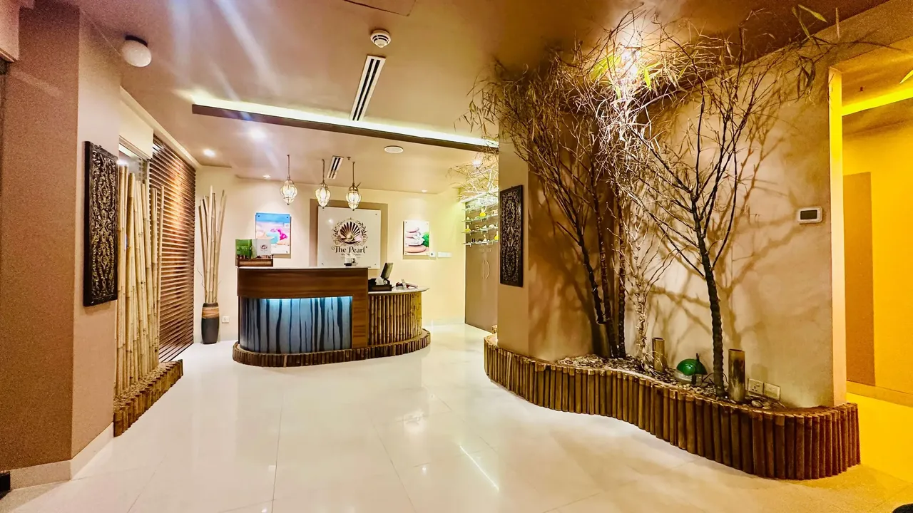 Reception of Pearl Spa with decorative branches along the wall