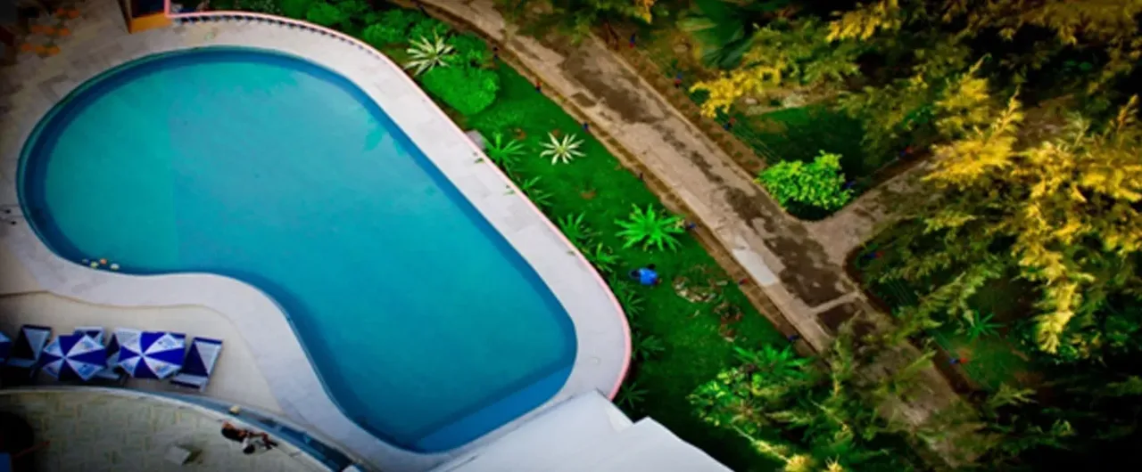 Swimming pool among the gardens at Praasad Paradise, seen from above