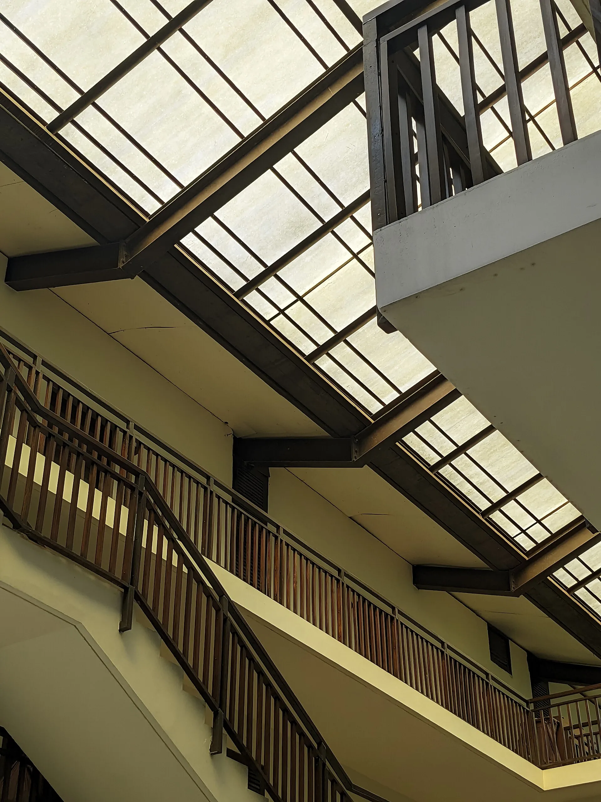 Glass-roofed atrium and staircase inside DuSai Resort & Spa