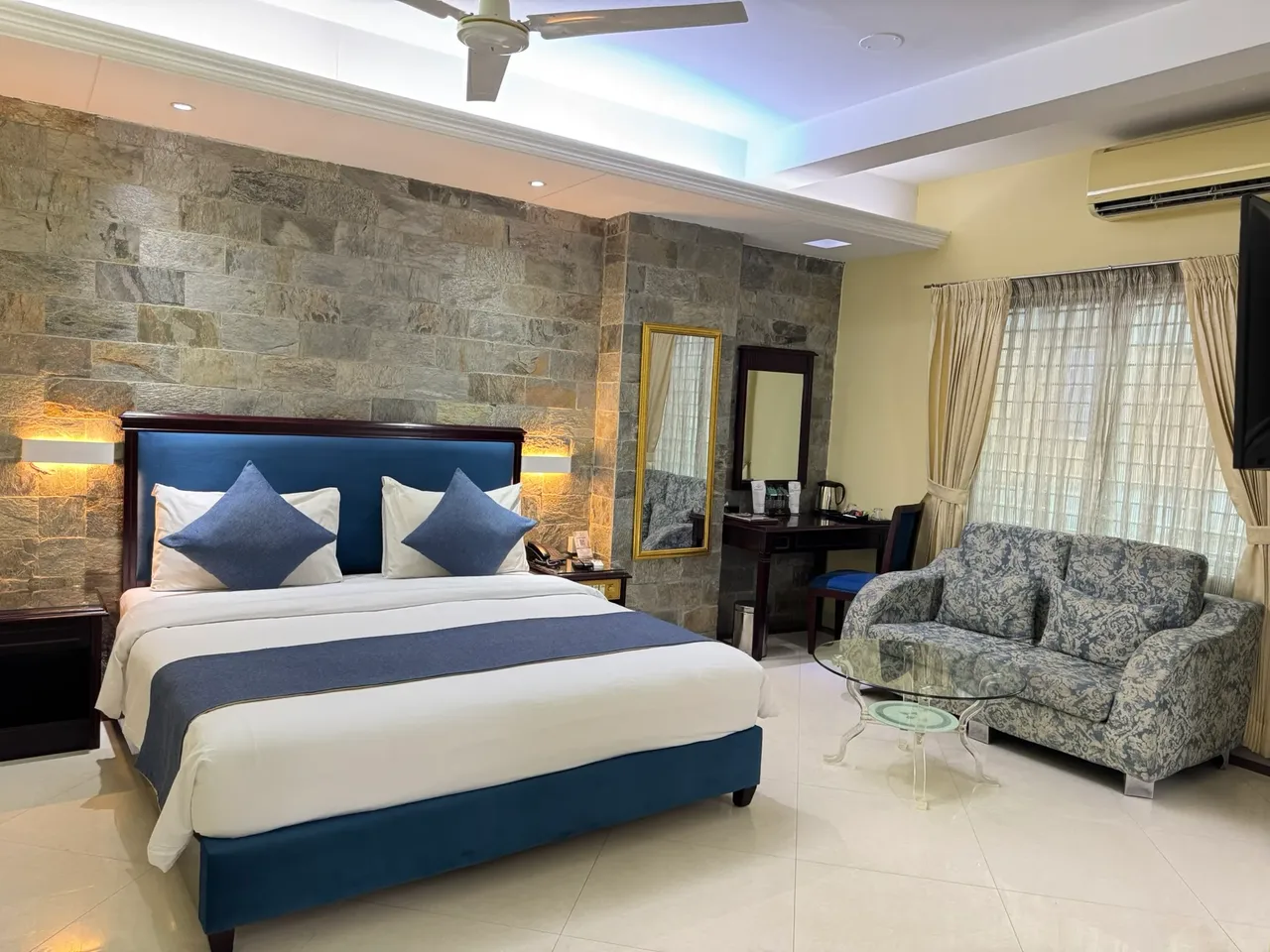Super Deluxe room with a king bed and sofa