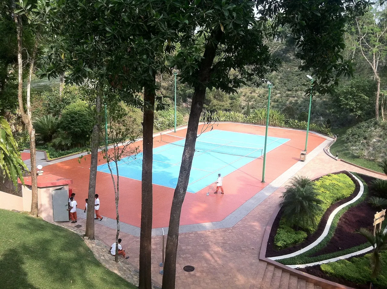 Tennis court among trees at the resort