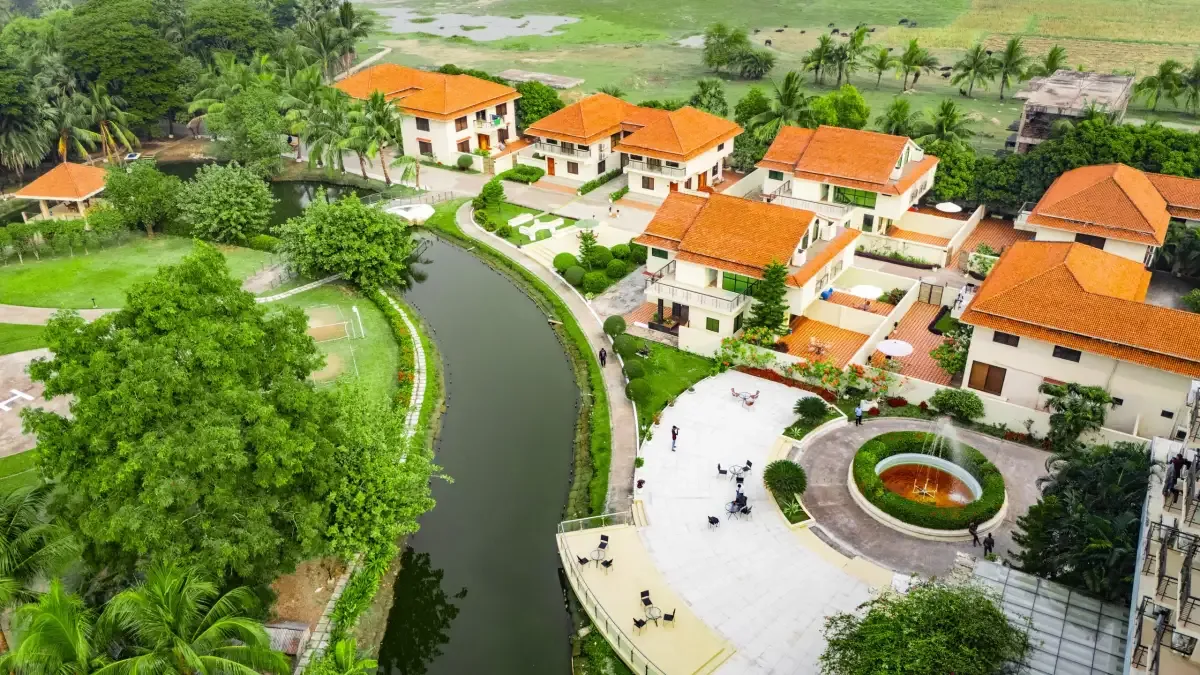 Red-roofed villas along a canal at Sikder Resort & Villas, seen from above